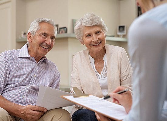 Elderly couple meets with lawyer to draw up their Medical Power of Attorney and other documents. Elderly couple meets with lawyer to draw up their Medical Power of Attorney and other documents need to guide others decisions regarding their medical care in the future when they are not able to.
