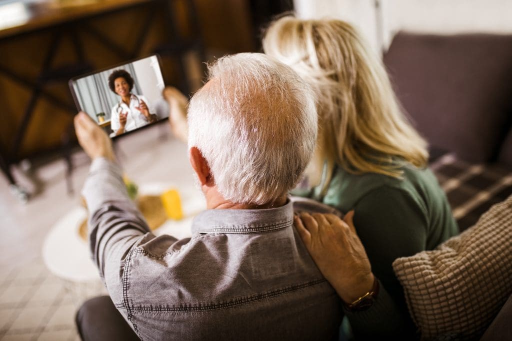 Image of a patient and their care partner participating in a telehealth visit.