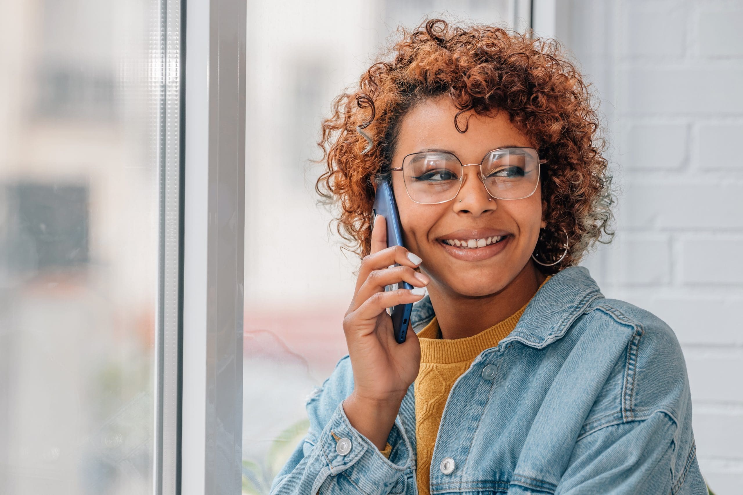 african american woman talking on mobile phone Woman on the telephone is keeping tabs on the hospital care of a loved one who lives far away.