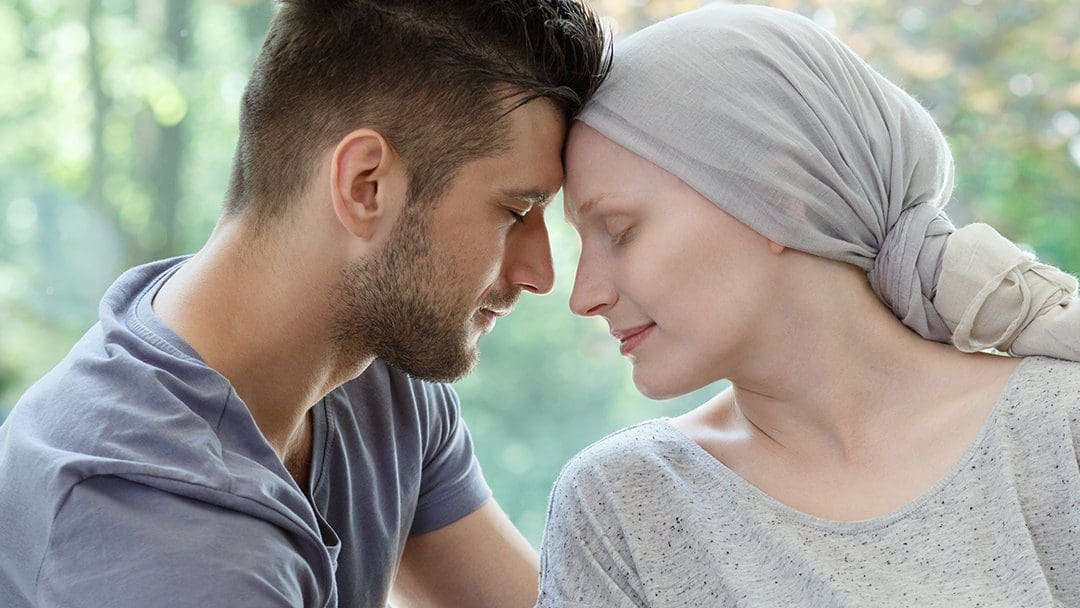 Palliative or Hospice Care-Husband comforts his wife during her cancer treatment. Husband comforts his wife during her cancer treatment.